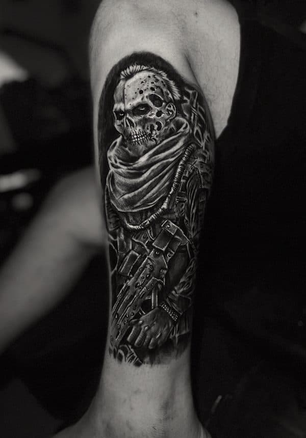 black and grey skull sleeve on an upper arm